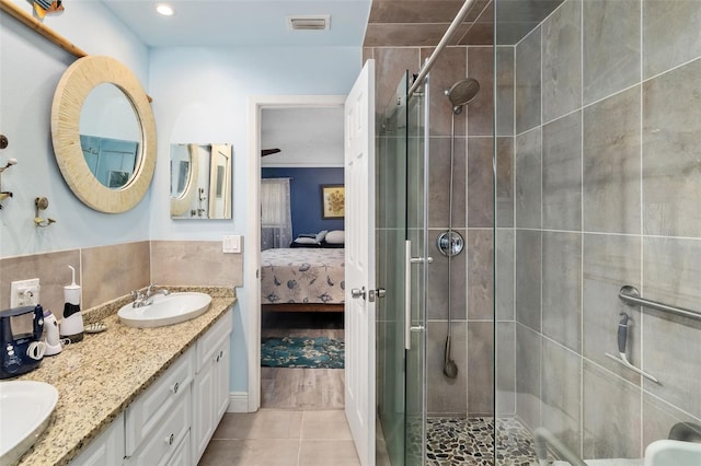 bathroom with vanity, an enclosed shower, and tile patterned floors