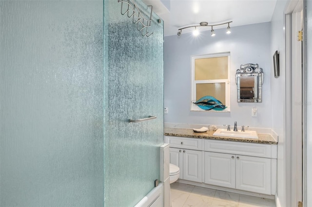 bathroom featuring vanity, toilet, and walk in shower