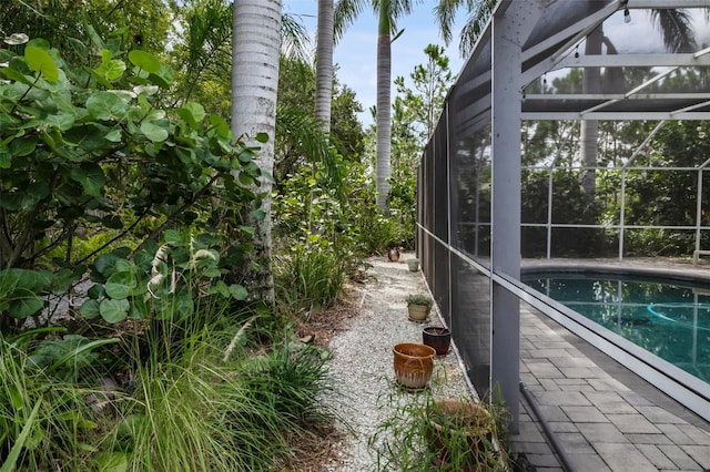 view of swimming pool with a lanai and a patio area