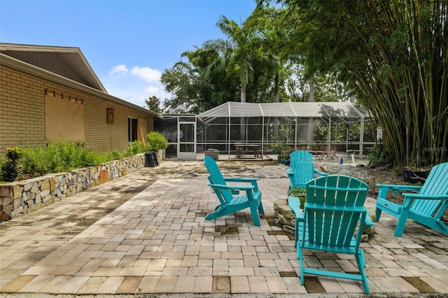 view of patio featuring a lanai and a fire pit