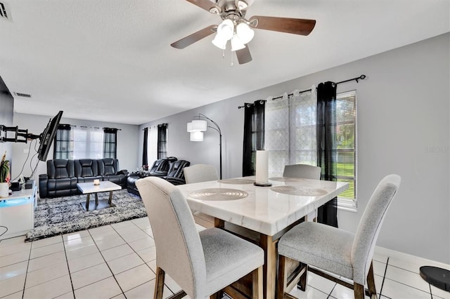 tiled dining room with ceiling fan