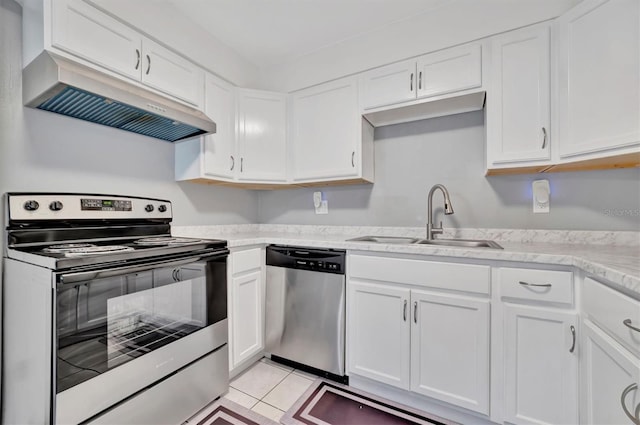 kitchen featuring appliances with stainless steel finishes, light tile patterned floors, sink, and white cabinets