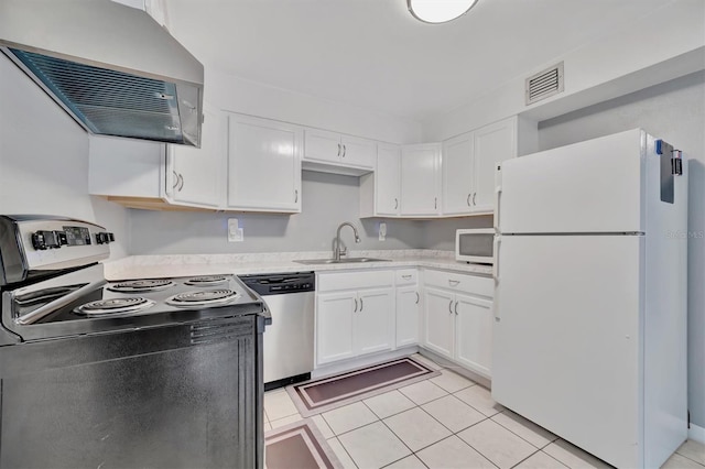 kitchen featuring white cabinetry, range hood, sink, appliances with stainless steel finishes, and light tile patterned flooring