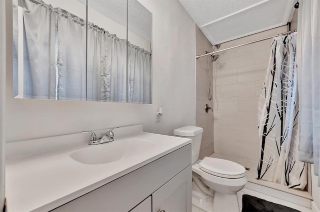 bathroom featuring a textured ceiling, vanity, toilet, and curtained shower