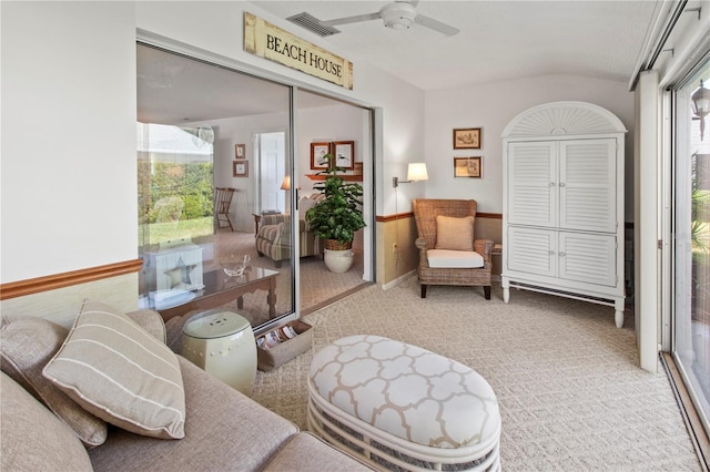 interior space with visible vents, carpet, ceiling fan, and vaulted ceiling