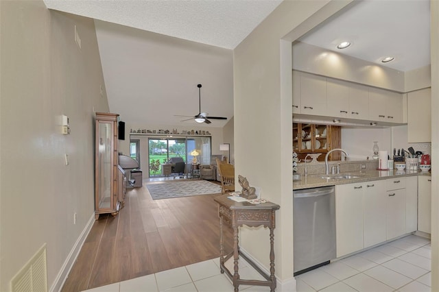 kitchen featuring white cabinets, dishwasher, light hardwood / wood-style flooring, sink, and ceiling fan