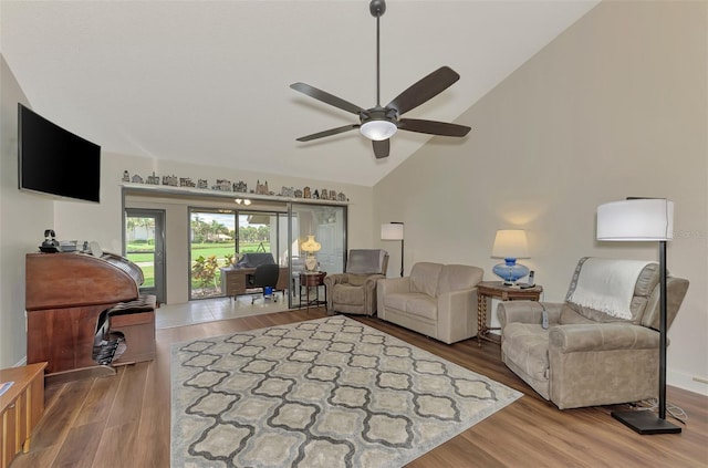 living room featuring high vaulted ceiling, hardwood / wood-style floors, and ceiling fan