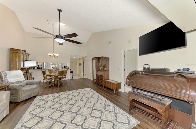 living room featuring a textured ceiling, dark wood-type flooring, ceiling fan, and high vaulted ceiling