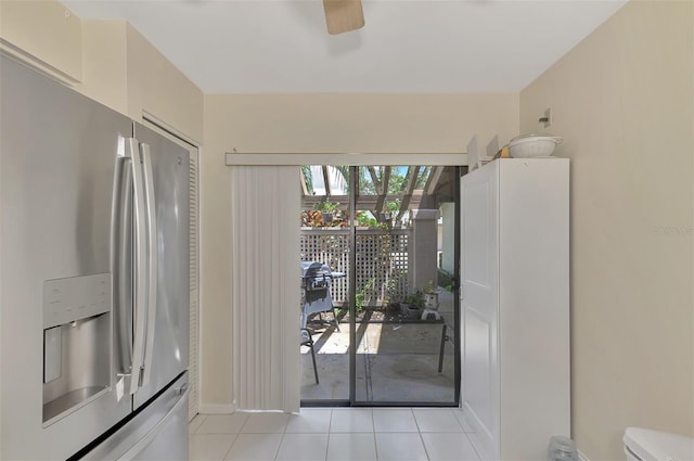 doorway to outside with ceiling fan and light tile patterned floors