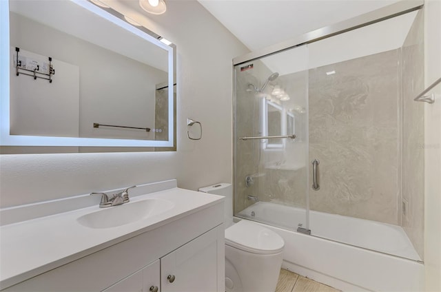 full bathroom with toilet, combined bath / shower with glass door, and vanity