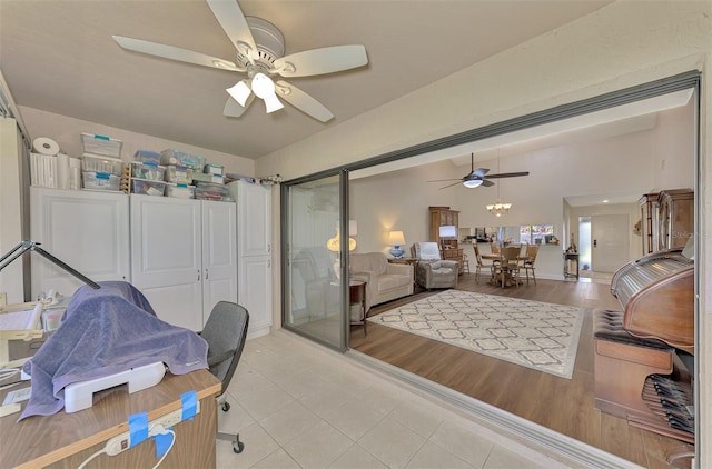 bedroom with a closet, ceiling fan with notable chandelier, and light hardwood / wood-style floors