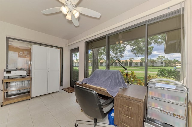 tiled home office featuring ceiling fan