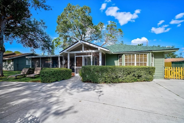 single story home featuring a sunroom