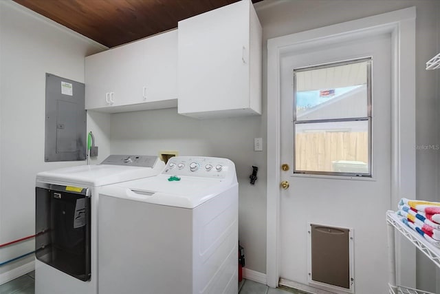 clothes washing area with washer and clothes dryer, light tile patterned floors, wooden ceiling, electric panel, and cabinets