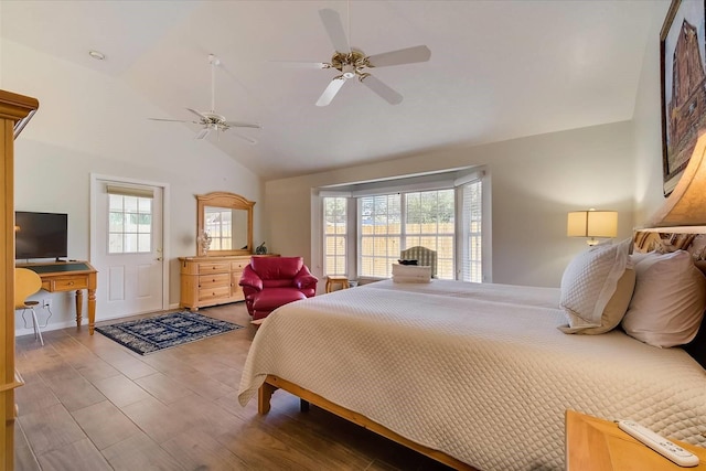 bedroom featuring ceiling fan, hardwood / wood-style floors, and vaulted ceiling