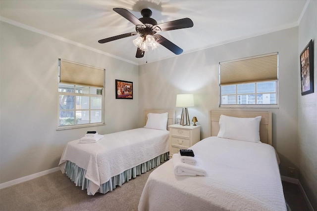 bedroom with ceiling fan, crown molding, and dark colored carpet