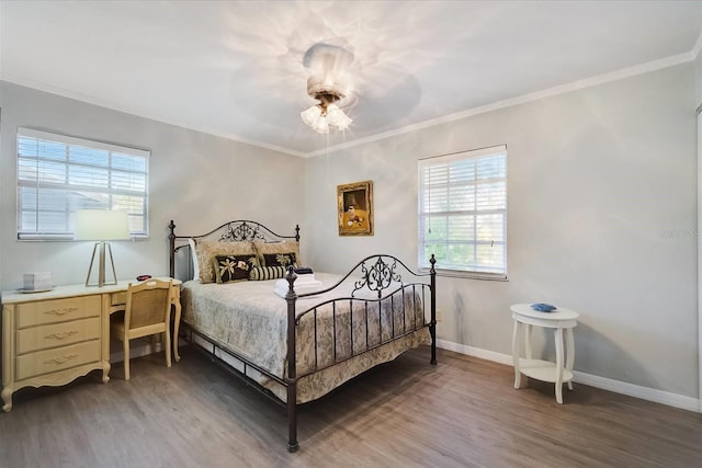 bedroom with ceiling fan, ornamental molding, and wood-type flooring