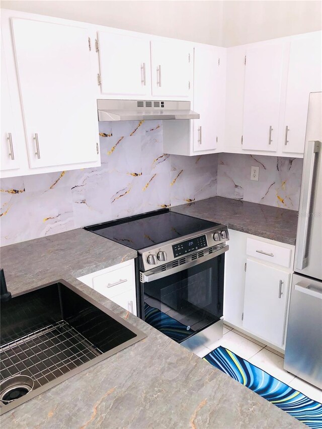 kitchen with white cabinets, stainless steel appliances, and decorative backsplash