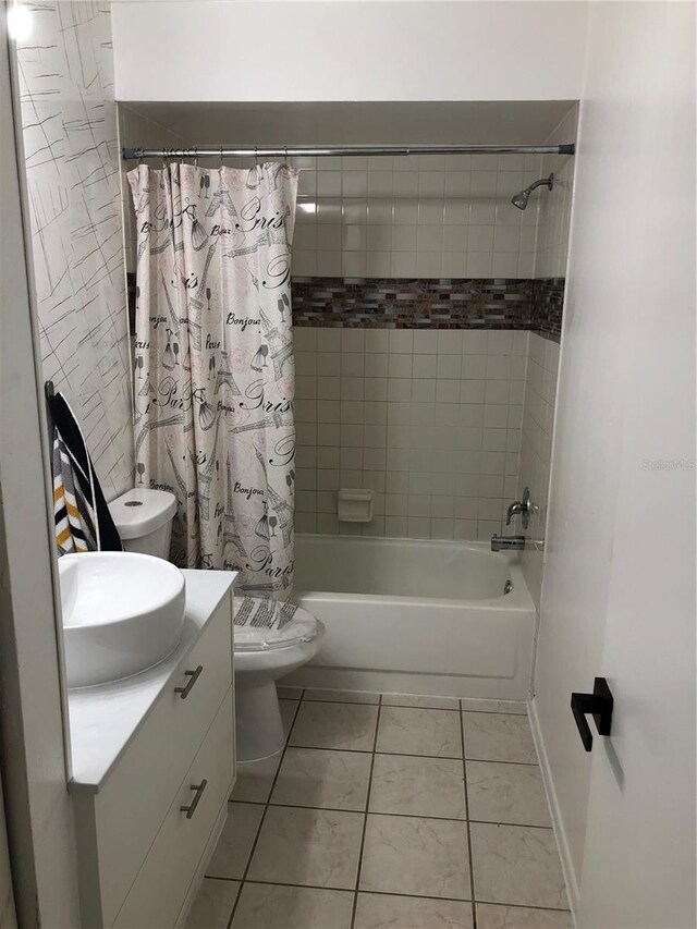 full bathroom featuring vanity, toilet, shower / tub combo with curtain, and tile patterned floors