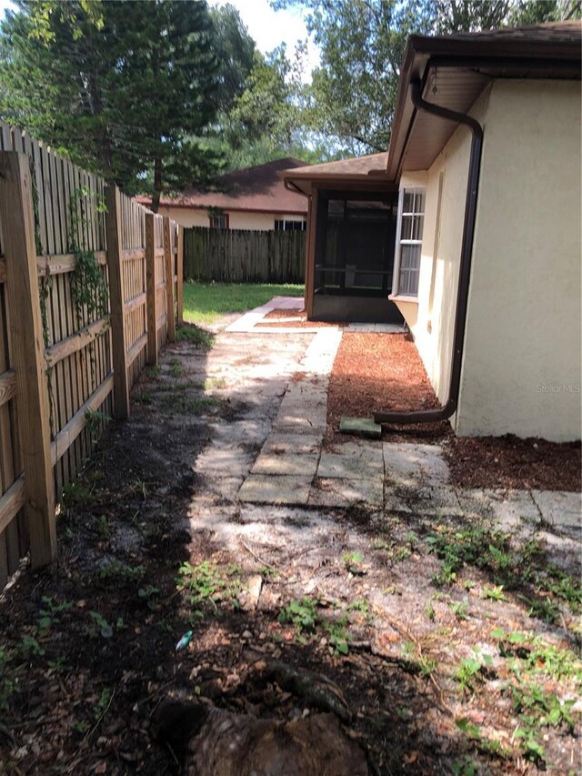 exterior space featuring a sunroom and a patio