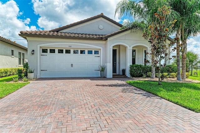 mediterranean / spanish home featuring a garage