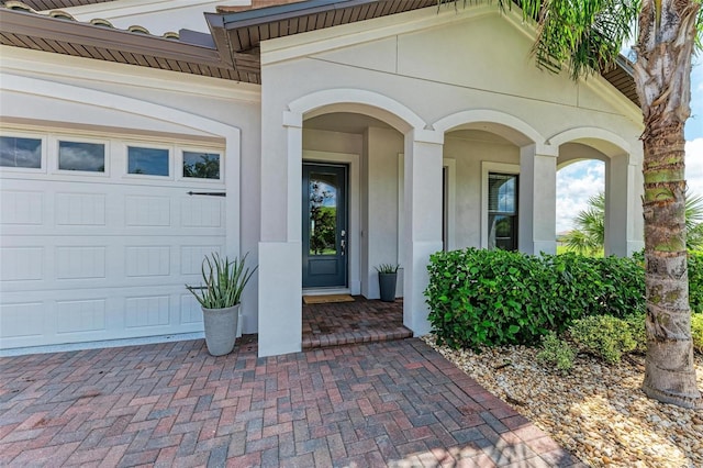 view of exterior entry with a garage