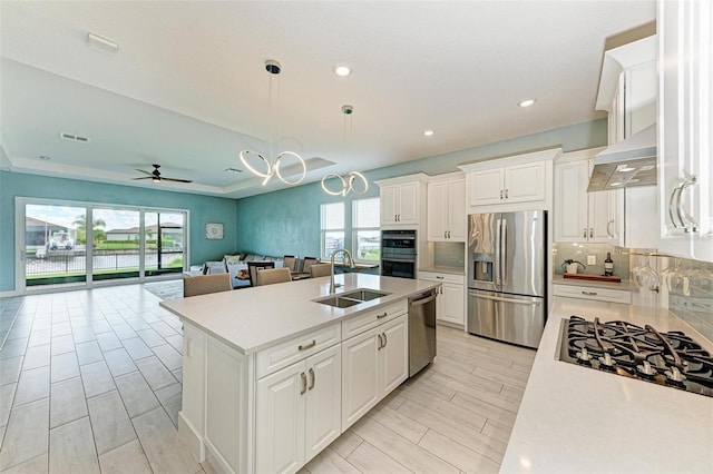 kitchen featuring white cabinets, ceiling fan, stainless steel appliances, and sink