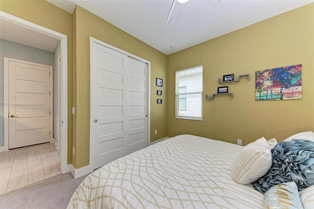 bedroom with carpet flooring, ceiling fan, and a closet