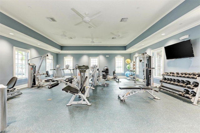 gym with crown molding, ceiling fan, and a tray ceiling