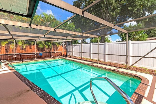 view of pool with glass enclosure