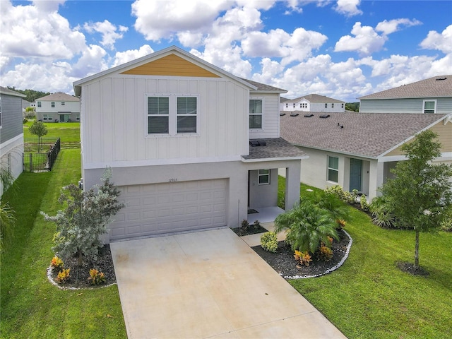 view of front of property featuring a garage and a front lawn