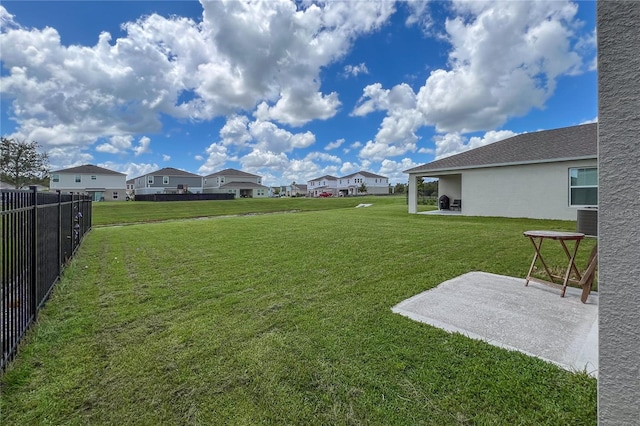 view of yard with central AC unit and a patio area