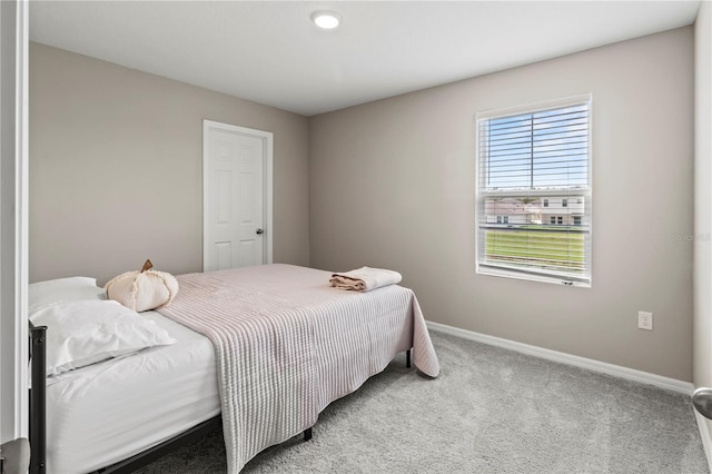 carpeted bedroom featuring multiple windows