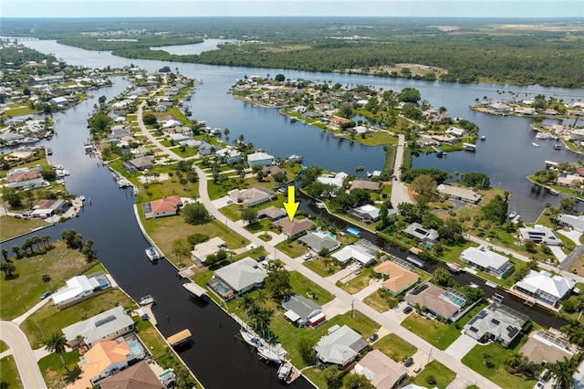 drone / aerial view with a water view and a residential view