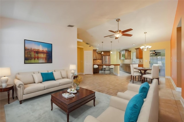13460 Marquette Blvd, Fort Myers, FL 33905 - living room with light tile patterned floors, lofted ceiling, visible vents, baseboards, and ceiling fan with notable chandelier