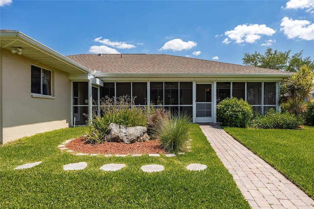13460 Marquette Blvd, Fort Myers, FL 33905 - view of front of property featuring roof with shingles, a front yard, a sunroom, and stucco siding