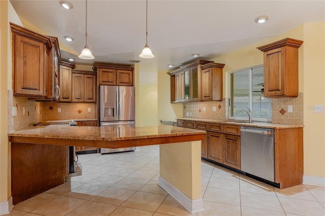 13460 Marquette Blvd, Fort Myers, FL 33905 - kitchen with light tile patterned floors, stainless steel appliances, light stone countertops, and brown cabinets