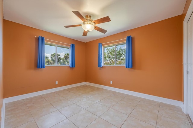 13460 Marquette Blvd, Fort Myers, FL 33905 - unfurnished room featuring a ceiling fan, a wealth of natural light, baseboards, and light tile patterned floors
