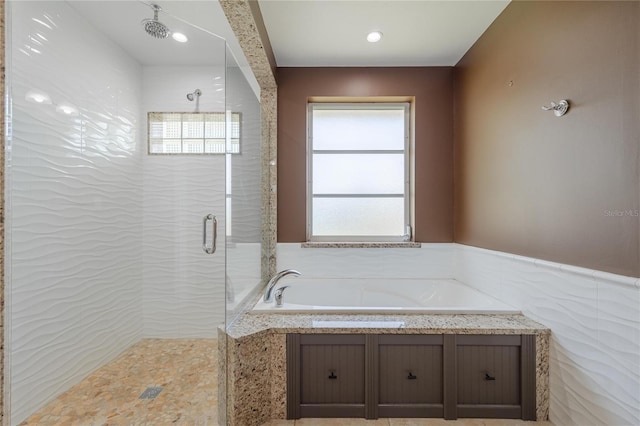 13460 Marquette Blvd, Fort Myers, FL 33905 - full bath featuring a wainscoted wall, tiled shower, tile walls, and a bath