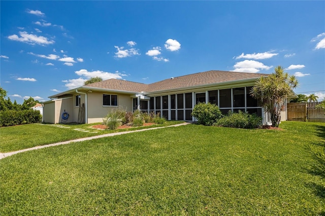 13460 Marquette Blvd, Fort Myers, FL 33905 - back of property with a lawn, fence, a sunroom, and stucco siding