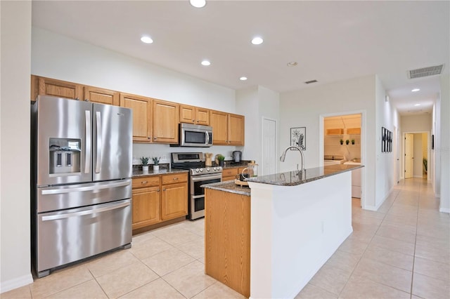 kitchen with light tile patterned floors, visible vents, appliances with stainless steel finishes, dark stone countertops, and recessed lighting