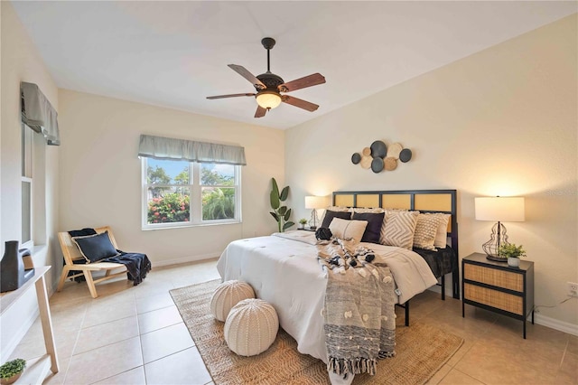 bedroom featuring light tile patterned floors, ceiling fan, and baseboards