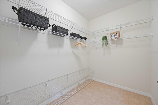 spacious closet featuring light tile patterned floors