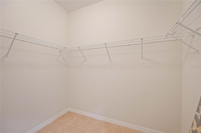 spacious closet with light tile patterned floors