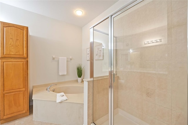 full bathroom featuring a garden tub, tile patterned flooring, and a shower stall