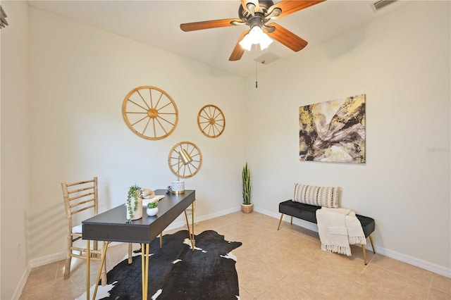 office featuring a ceiling fan, visible vents, baseboards, and light tile patterned floors