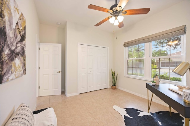 home office featuring light tile patterned floors, baseboards, and a ceiling fan