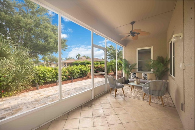 sunroom featuring ceiling fan