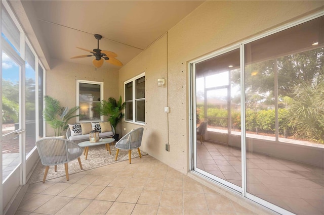 sunroom featuring ceiling fan