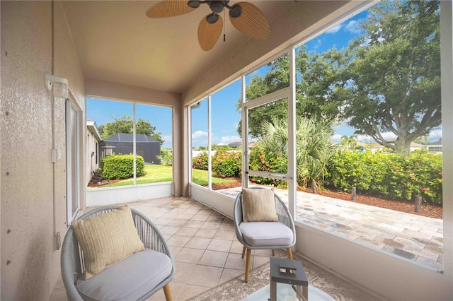 sunroom featuring a ceiling fan